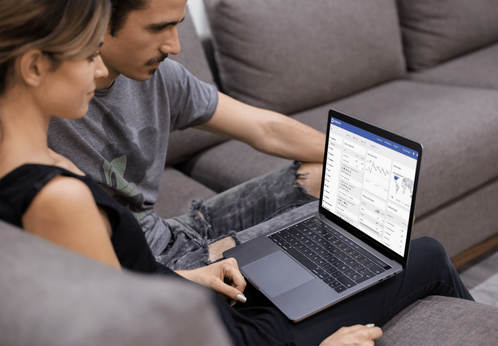 Woman and man looking at Matomo Analytics dashboard on laptop screen.
