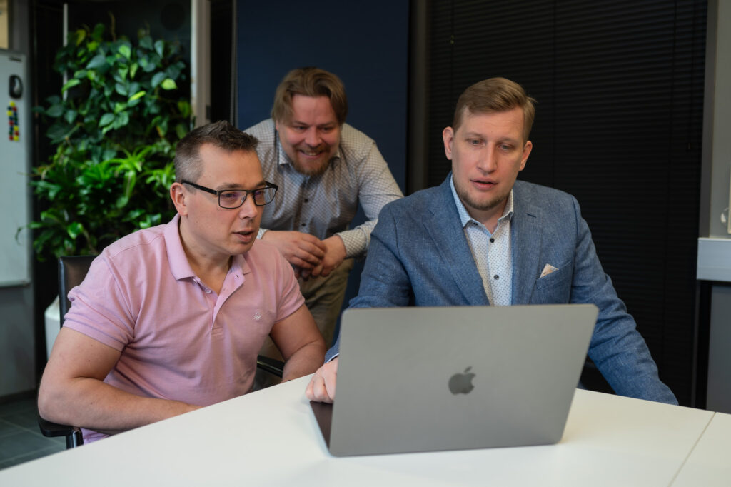 Three men working with laptop