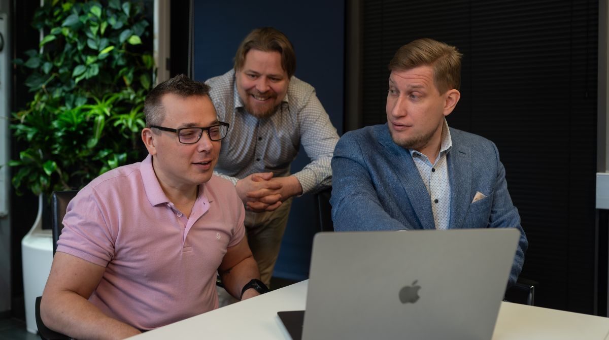 Three men discussing about the topic seen on the screen.