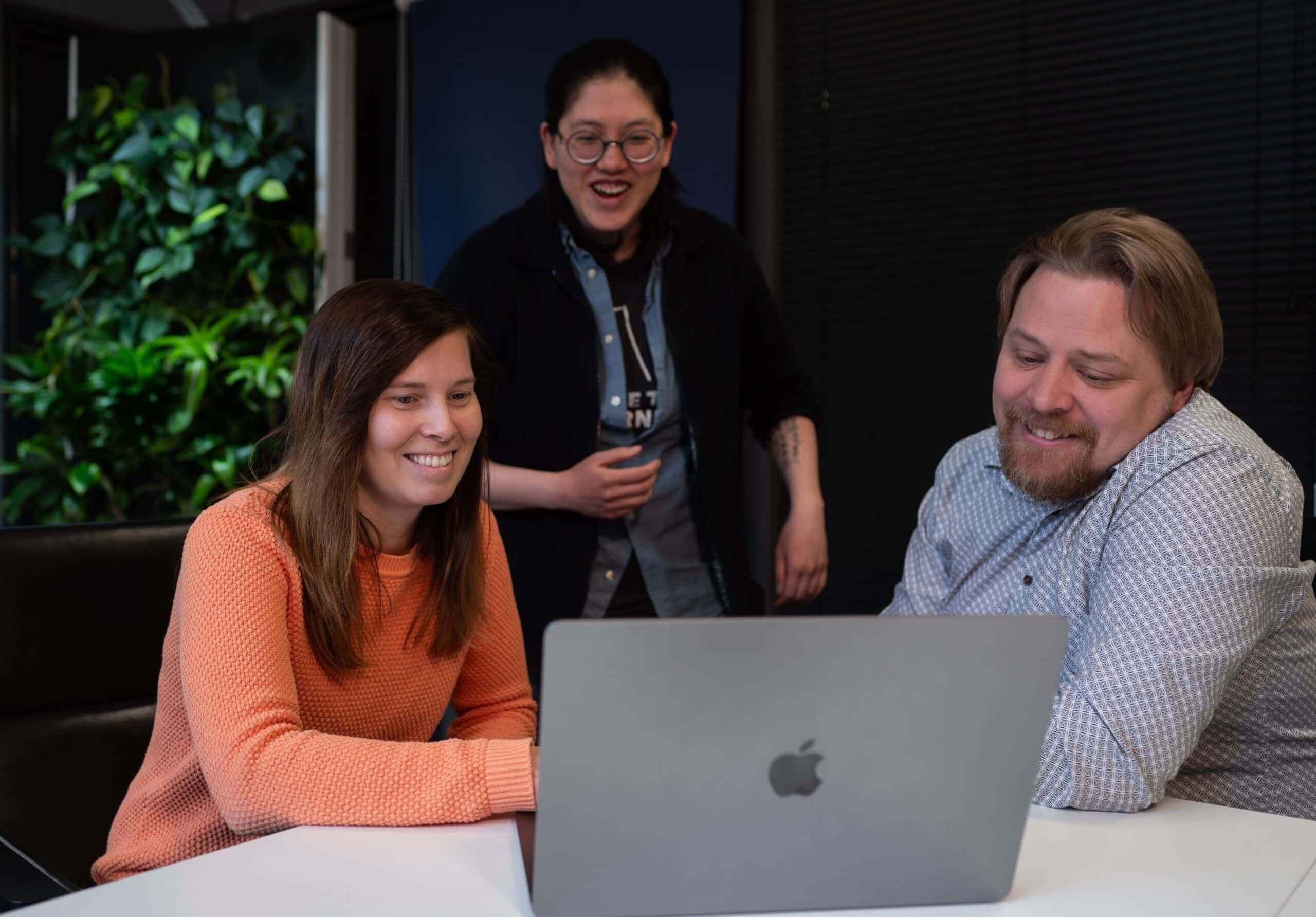 3 people working together with laptop on meeting room